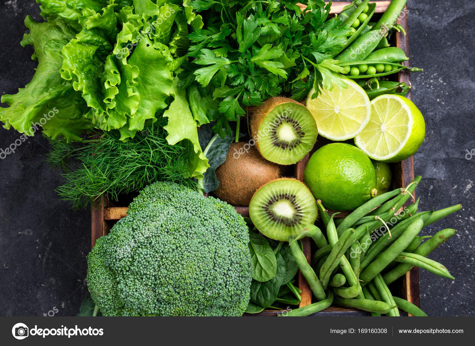 Green vegetables background. Broccoli, spinach, kiwi, lettuce, parsley
