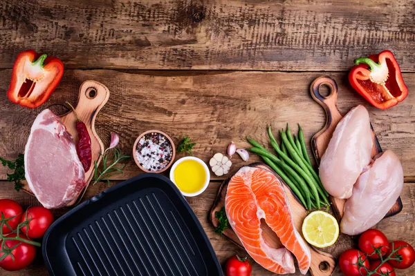 Healthy food background. Meat, fish, vegetables,pan for cooking grill. Healthy eating concept. Top view