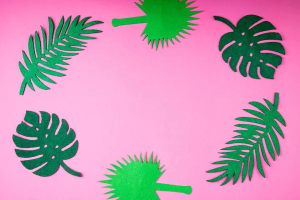 Summer trendy background with leaves on pink. Handmade palm leaves. Felt toy. Idea summer art crafts for kids in camp arts