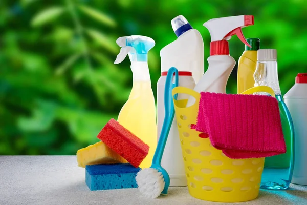 Basket with cleaning products on blue background. Cleaning with