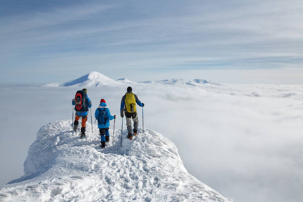 hikers are above the clouds