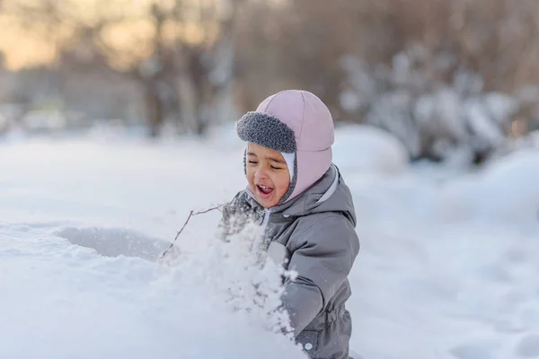 Cute child playing with snow