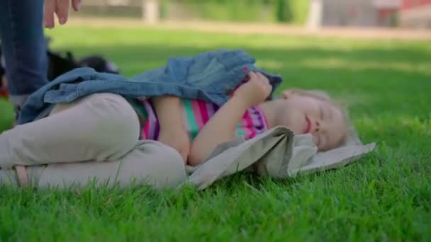 Petite fille reposant sur l'herbe . — Video