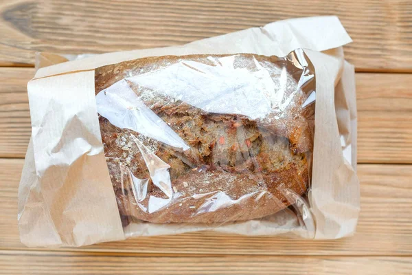 Bread in a paper bag. Transparent packaging. View from above