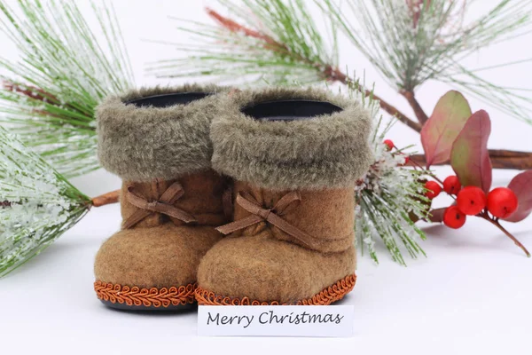 Merry Christmas card with mini felt shoes and pine covered with snow flakes — Stock Photo, Image
