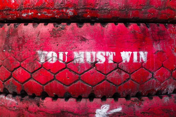 Inscription on the big old tire, colored in red.