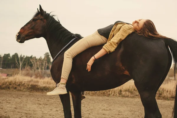 Mujer relajándose en la espalda de un hermoso caballo —  Fotos de Stock