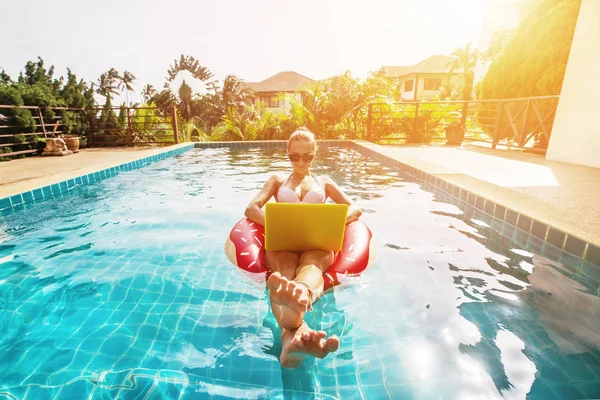 woman in swimming ring in pool