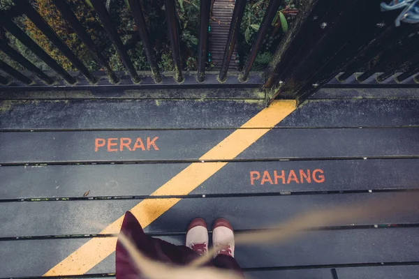 Sign of border between states in Malaysia Perak and Pahang in Mossy forest view point