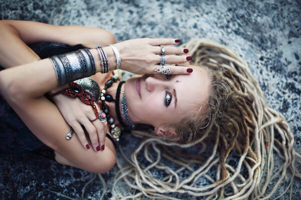 Gypsy boho style young woman wearing dreadlocks and  tribal jewellery portrait