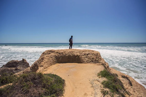 Портрет Африканца Стоящего Красивой Скале Смотрящего Океан Наслаждается Моторным Отдыхом — стоковое фото