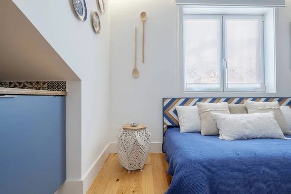 Modern apartment interior design in blue colours,  small and cozy bed room