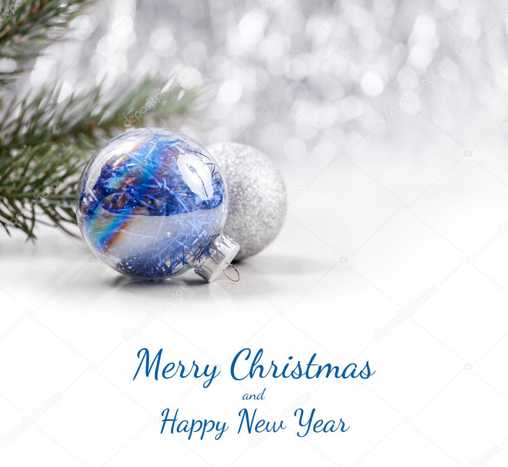 Silver and Blue Christmas ornaments balls on glitter bokeh background with space for text. Xmas and Happy New Year theme