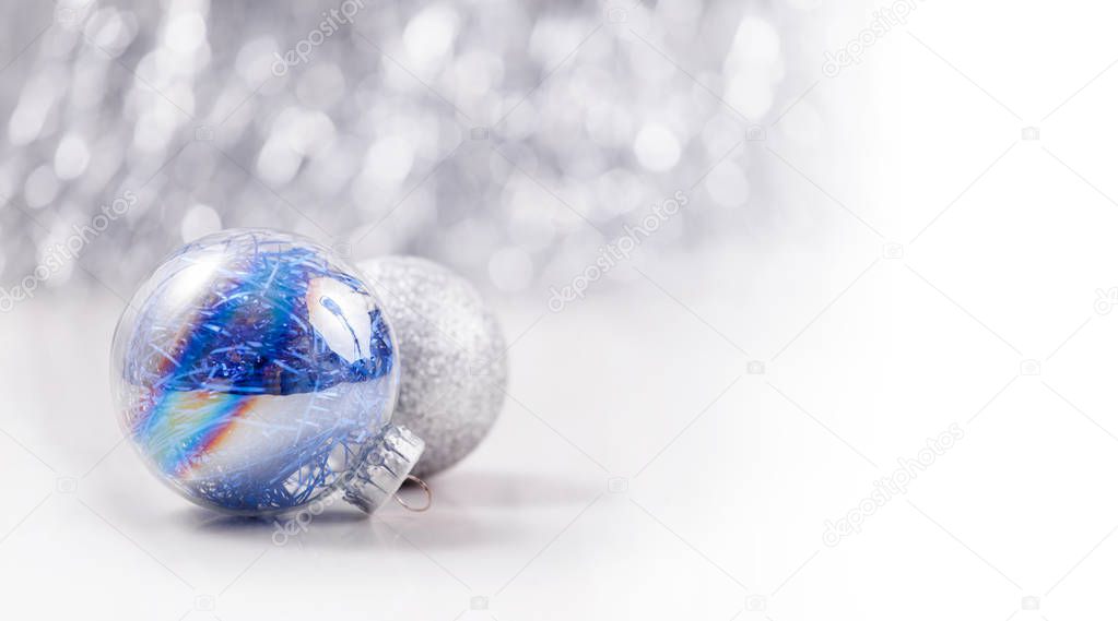 Silver and Blue Christmas ornaments balls on glitter bokeh background with space for text. Xmas and Happy New Year theme