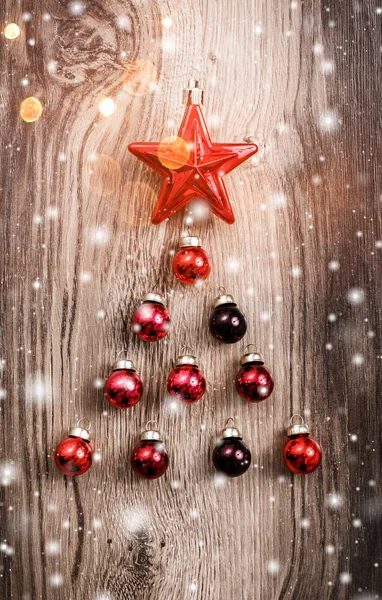 Red Christmas ornaments on wooden holiday background. Xmas and Happy New Year composition. Flat lay, top view