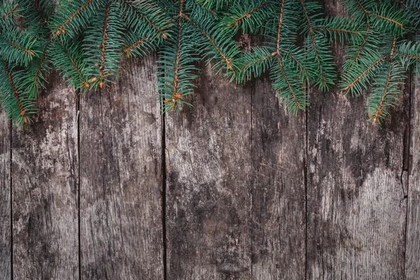 Christmas Fir branches on wooden background. Xmas and Happy New Year composition. Flat lay, top view. Copy space — Stock Photo, Image