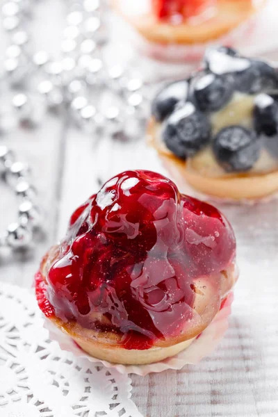 Las tartas de frutas con bayas y fresas sobre fondo claro se cierran. Delicioso postre y dulces. Vista superior — Foto de Stock