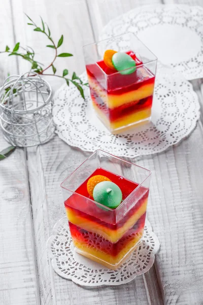 Fruchtdessert Panna Cotta mit Bonbons in einem Glas auf hellem Hintergrund in Großaufnahme. Ansicht von oben. — Stockfoto