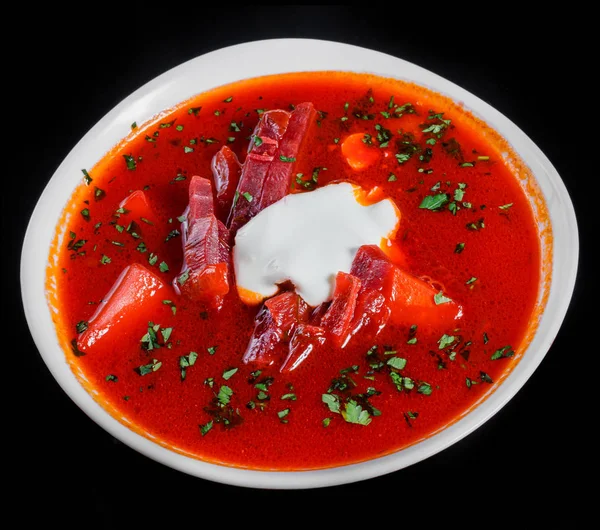Ukrainian and Russian traditional beetroot soup - borscht in bowl with sour cream and herbs, isolated on black background, healthy food. Top view — Stock Image Ukrainian and Russian traditional beetroot soup - borscht in bowl with sour cream and herbs, isolated on black background, healthy food. Top view Stock Picture