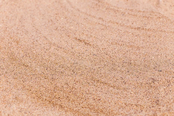 Sand on the beach as background with space for the text. Sea travel and holiday. Selective focus — Stock Photo, Image