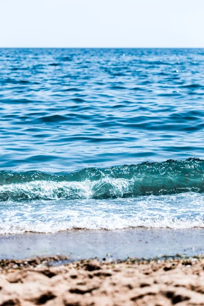 Güneşli gökyüzü ile tropikal plaj deniz manzara. Deniz seyahat ve tatil. Seçici odak