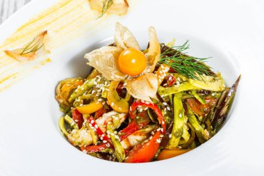 Salata tavuk göğsü ve ızgara sebzeler, patlıcan, tatlı biber, domates, avokado ve ahşap arka plan üzerinde plaka üzerinde physalis kapatın. Üstten Görünüm