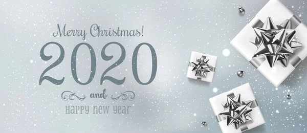 Merry Christmas and New Year 2020 Text on light background with gift boxes, silver bows, ribbons, decoration, sparkles, bokeh. Xmas holiday, realistic vector, top view Stock Illustration