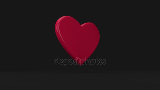 Rotating and floating heart on black background — Stock Video