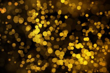 Koyu arka plan üzerinde spot altın bokeh