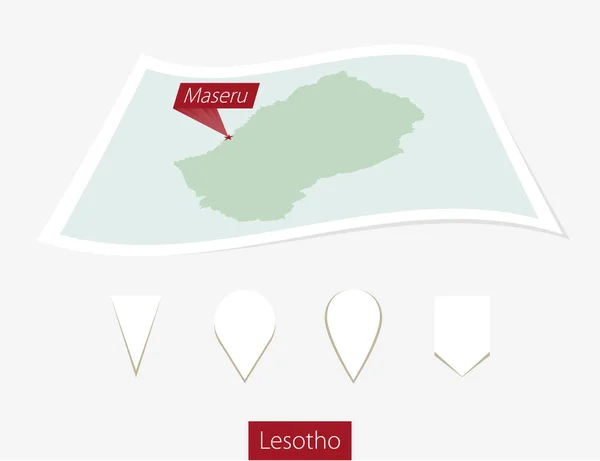 Gebogene Papierkarte von Lesotho mit Maseru auf grauem Hintergrund. — Stockvektor