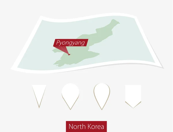 Mapa de papel curvo de Coréia do Norte com a capital Pyongyang no fundo cinza . — Vetor de Stock