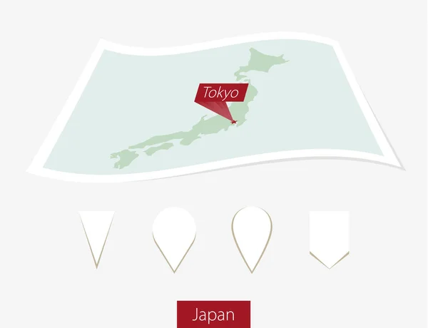 Gebogene Papierkarte von Japan mit großem Tokyo auf grauem Hintergrund. — Stockvektor