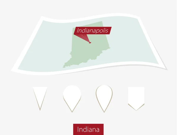 Mapa en papel curvado del estado de Indiana con la capital Indianápolis sobre fondo gris . — Vector de stock