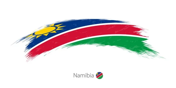 Vlag van Namibië in afgeronde grunge penseelstreek. — Stockvector