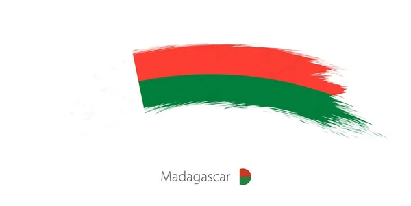 Vlajka Madagaskaru v tahu štětce zaoblené grunge. — Stockový vektor