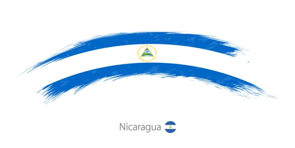 Flag of Nicaragua in rounded grunge brush stroke. — Stock Vector