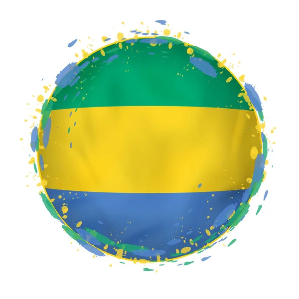 Bandera grunge redonda de Gabón con salpicaduras en el color de la bandera . — Vector de stock