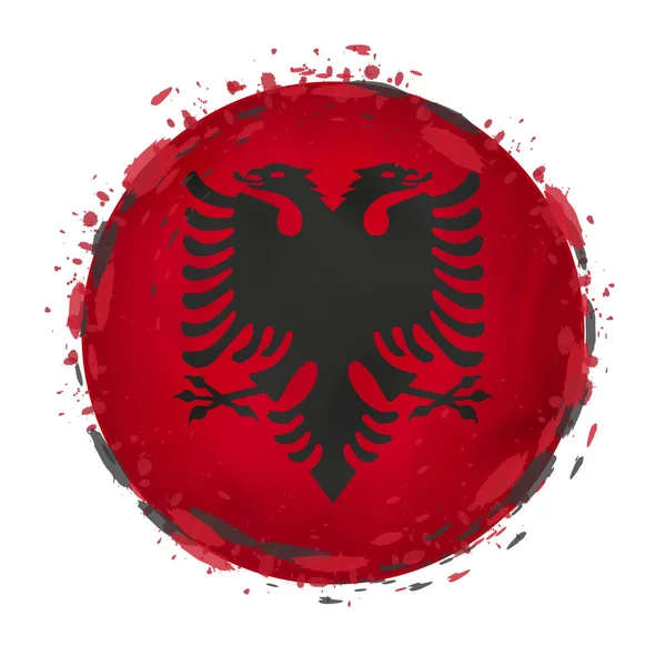 Round grunge flag of Albania with splashes in flag color. — Stock Vector