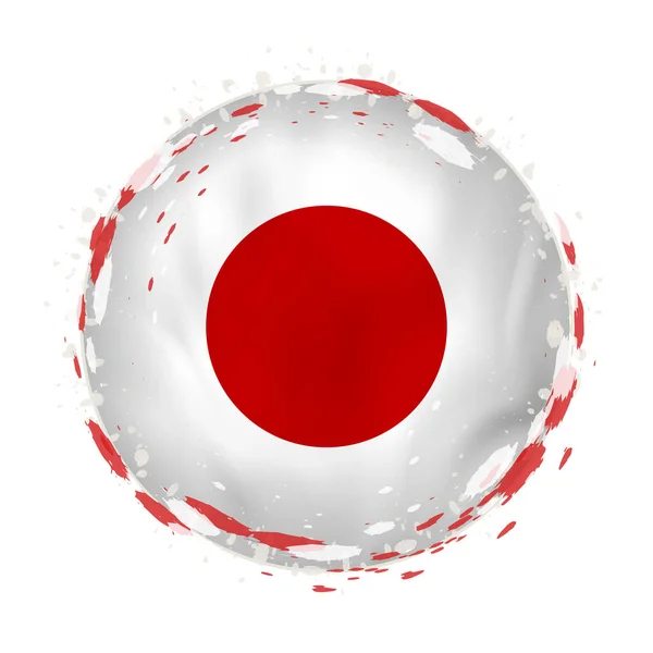 Runde Grunge-Flagge von Japan mit Spritzern in Flaggenfarbe. — Stockvektor