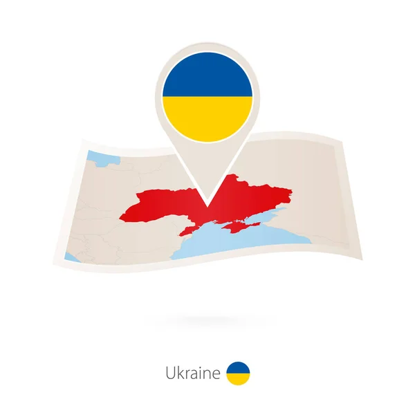 Skládané papírové mapy Ukrajiny s pin vlajka Ukrajiny. — Stockový vektor