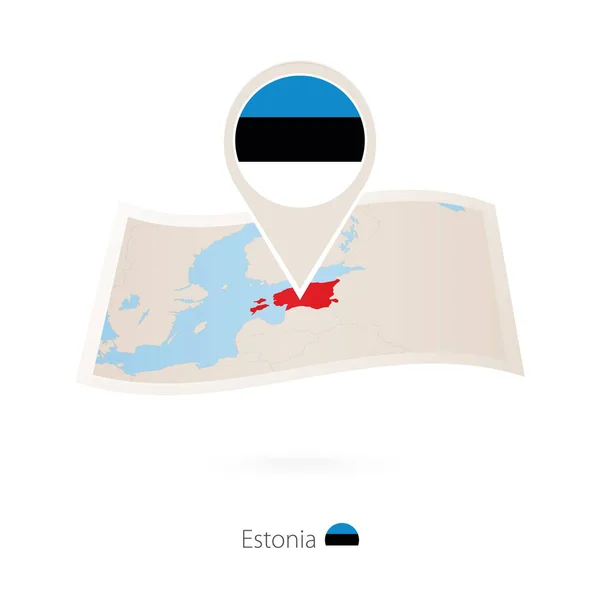 Gevouwen papieren kaart van Estland met vlag pin van Estland. — Stockvector