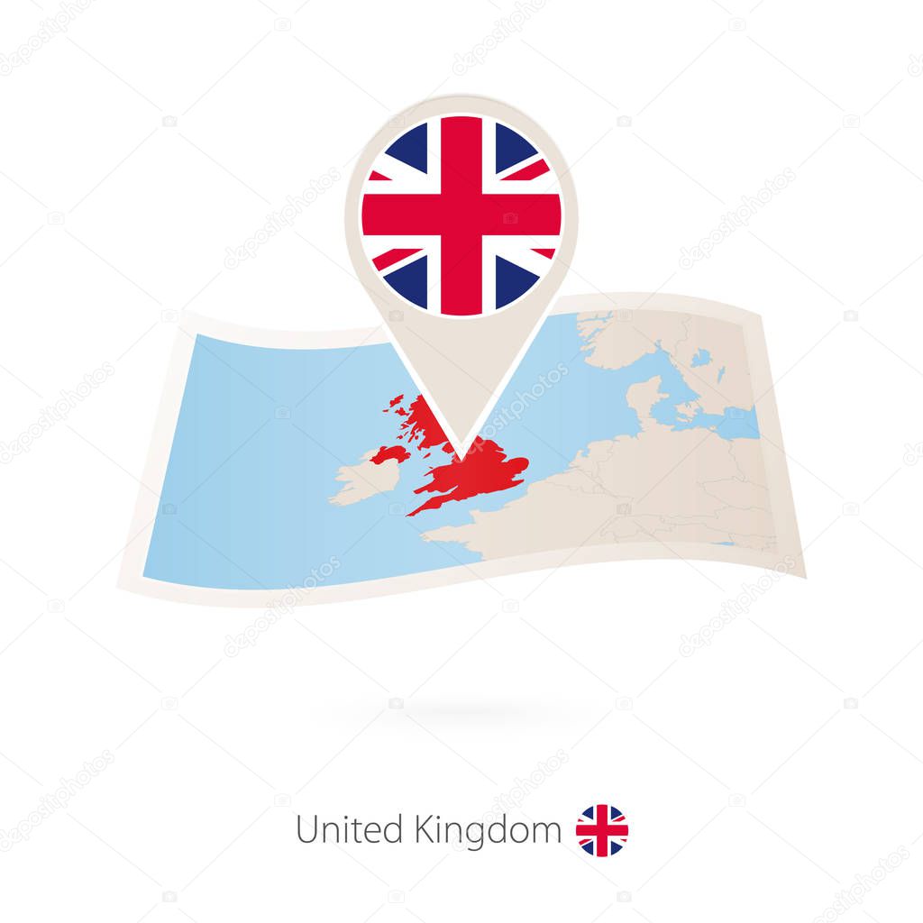 Folded paper map of United Kingdom with flag pin of UK.