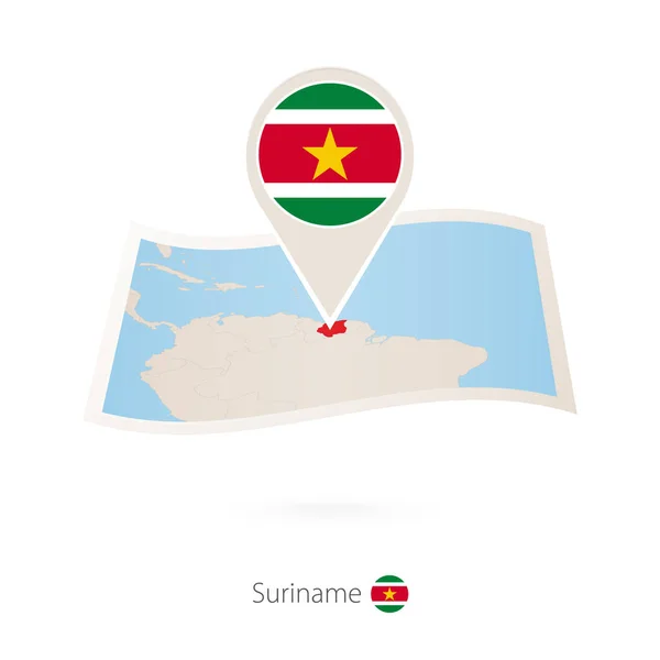 Skládané papírové mapy surinamské s vlajkou pin ze Surinamu. — Stockový vektor
