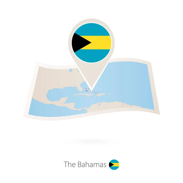 Gefaltete Papierkarte der Bahamas mit Fahnennadel der Bahamas. — Stockvektor