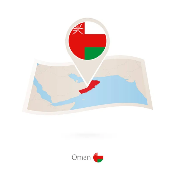 Skládané papírové mapa Ománu s pin vlajka Ománu. — Stockový vektor