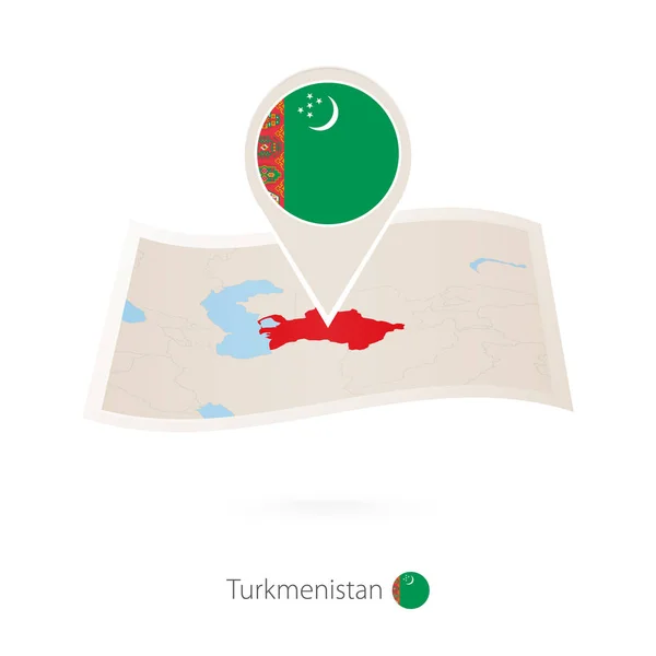 Carte papier de Turkménistan pliée avec broche du drapeau de Turkménistan . — Image vectorielle