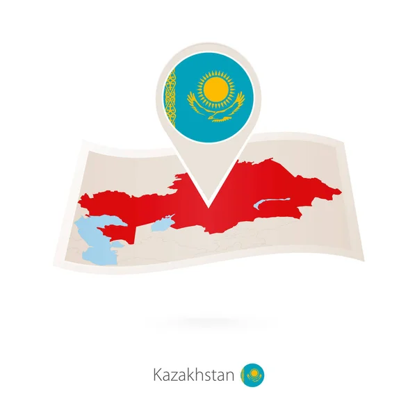 Gefaltete Papierkarte von Kasachstan mit Fahnennadel von Kasachstan. — Stockvektor