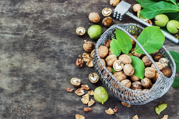 Noci intere e ripulite nel cestino Sfondo in legno nero Vista dall'alto Concetto sano — Foto Stock