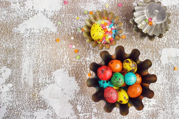 Colored easter eggs and baking molds on a light canvas background,place for text — Stock Photo, Image