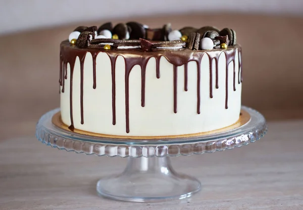 Ünnepi torta csokoládéval az asztalon egy könnyű háttér — Stock Fotó